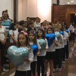 Alunos erguem balões azuis durante a Coroação de Nossa Senhora