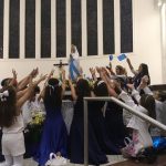 Alunos erguem balões azuis durante a Coroação de Nossa Senhora