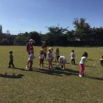 Crianças em atividade no campo durante a colônia Super Férias
