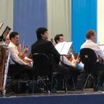 Orquestra Sinfônica de Campinas tocando durante a apresentação no ginásio