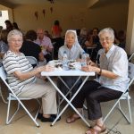 Participantes reunidos às mesas no encontro da Festa de Nossa Senhora do Calvário