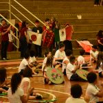 Apresentação de dança típica no ginásio durante a Semana Cultural