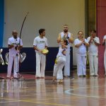 Apresentação de capoeira no ginásio durante a Semana Cultural