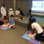 Participantes praticam reanimação em manequins no treinamento de primeiros socorros