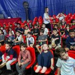 Crianças assistem ao filme na sessão de cinema do Férias no Coração
